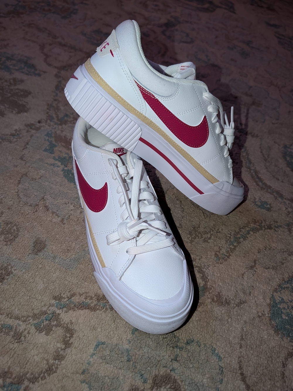 Nike White Low-Top Sneakers with Pink Swoosh and Gold Trim